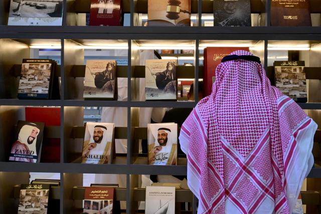 A man attends the Sharjah International Book Fair in the Gulf emirate of Sharjah, on November 6, 2025. (Photo by Giuseppe CACACE / AFP)