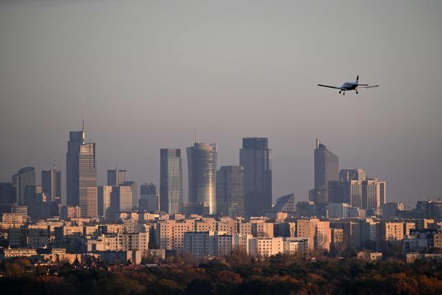 A Piper Cherokee Warrior II airplane lands at Warsaw Babice Airport with Warsaw's skyscrapers in the background, as seen from the village of Klaudyn, Masovian Voivodeship on November 6, 2025. (Photo by Sergei GAPON / AFP)
