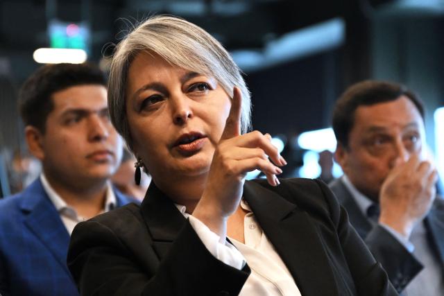 Chile's presidential candidate Jeannette Jara (L), of the Unidad por Chile coalition, gestures during a meeting with Cooperatives of Chile, a national association founded in 2018 that represents and advocates for cooperative organizations across the country, in Santiago, on November 6, 2025. Chile will hold the presidential election on November 16. (Photo by RODRIGO ARANGUA / AFP)