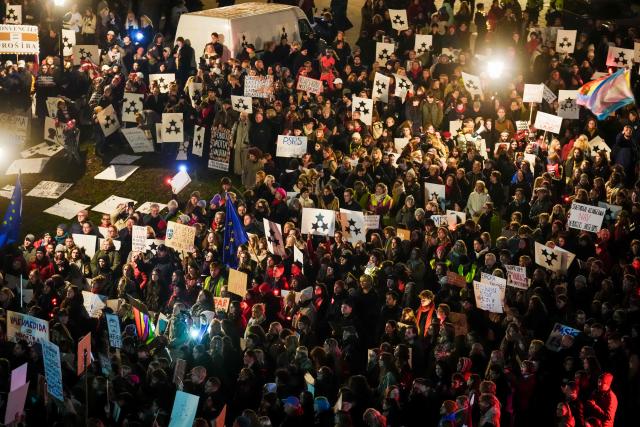 Thousands of demonstrators protest with banners and placards on November 6, 2025 at the Dome Square in Riga, against Latvia's bid to withdraw from the Istanbul Convention, designed to protect women from gender-based an domestic violence. Rights activists and Latvia's President had criticised the initial decision by lawmakers to pull out of the Convention. He returned the bill to the parliament for reconsideration on November 3, 2025, saying in a statement it "sent a contradictory message to both Latvian society and Latvia's allies". He also called for a national law on protecting women to be passed before taking a decision on leaving the Convention. (Photo by Gints Ivuskans / AFP)