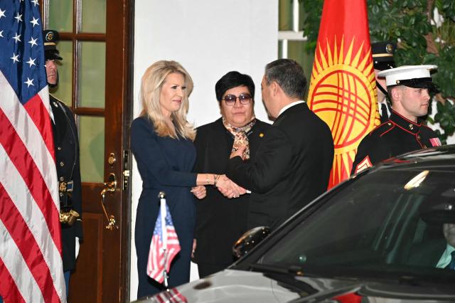 US Chief of Protocol Monica Crowley (L) greets Kyrgyzstan's President Sadyr Japarov (R) upon arrival at the West Wing of the White House in Washington, DC on November 6, 2025. US President Donald Trump is hosting a multilateral meeting with Central Asian countries. (Photo by Mandel NGAN / AFP)
