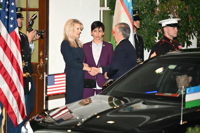US Chief of Protocol Monica Crowley (L) greets Uzbekistan's president Shavkat Mirziyoyev (R) upon arrival at the West Wing of the White House in Washington, DC on November 6, 2025. US President Donald Trump is hosting a multilateral meeting with Central Asian countries. (Photo by Mandel NGAN / AFP)