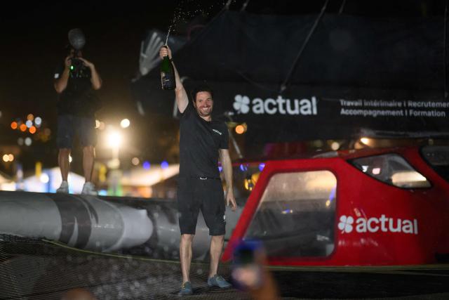 "Actual" Ultim multihull French skipper Anthony Marchand sprays champagne after placing third in the Ultim class of 17th edition of the Transat Cafe L'Or, off the shores of Fort-de-France, in the French overseas island of Martinique on November 6, 2025. Four open classes will take part in the race: IMOCA, Ocean Fifty, ULTIM and Class40. Four open classes take part in the race: IMOCA, Ocean Fifty, ULTIM and Class40. The Transat Cafe L'Or is a duo sailing race from Le Havre to Fort-de-France, in the French Caribbean island of Martinique. (Photo by Loic VENANCE / AFP)