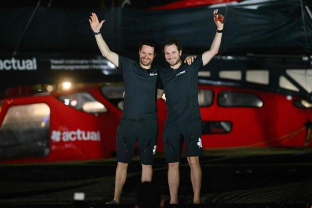 "Actual" Ultim multihull French skippers Julien Villion (R) and Anthony Marchand celebrate after placing third in the Ultim class of 17th edition of the Transat Cafe L'Or, off the shores of Fort-de-France, in the French overseas island of Martinique on November 6, 2025. Four open classes take part in the race: IMOCA, Ocean Fifty, ULTIM and Class40. The Transat Cafe L'Or is a duo sailing race from Le Havre to Fort-de-France, in the French Caribbean island of Martinique. (Photo by Loic VENANCE / AFP)