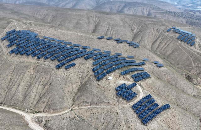 This aerial photo shows solar panels on barren mountains in Haiyuan County, Zhongwei city, northern China's Ningxia province on November 6, 2025. (Photo by AFP) / China OUT