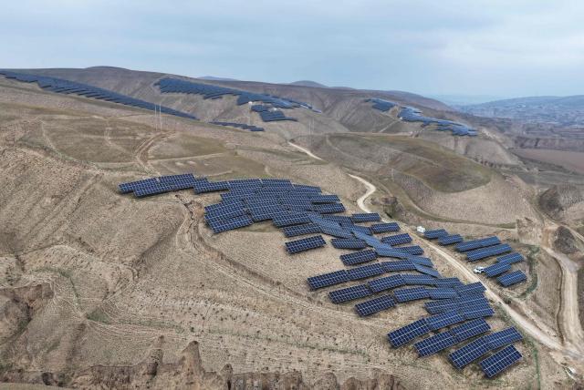 This aerial photo shows solar panels on barren mountains in Haiyuan County, Zhongwei city, northern China's Ningxia province on November 6, 2025. (Photo by AFP) / China OUT
