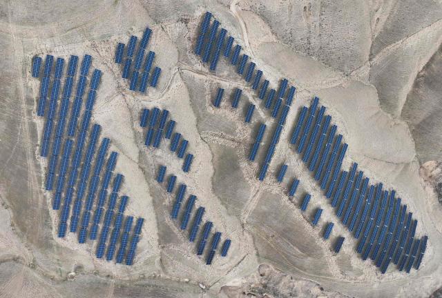 This aerial photo shows solar panels on barren mountains in Haiyuan County, Zhongwei city, northern China's Ningxia province on November 6, 2025. (Photo by AFP) / China OUT