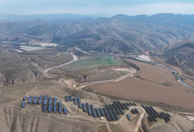 This aerial photo shows solar panels on barren mountains in Haiyuan County, Zhongwei city, northern China's Ningxia province on November 6, 2025. (Photo by AFP) / China OUT