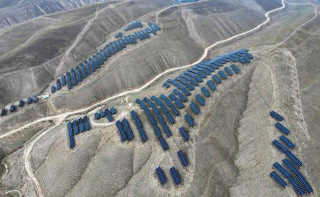 This aerial photo shows solar panels on barren mountains in Haiyuan County, Zhongwei city, northern China's Ningxia province on November 6, 2025. (Photo by AFP) / China OUT