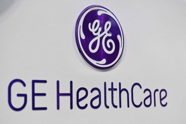 A logo of GE HealthCare is seen at the company stand during the 8th China International Import Expo (CIIE) in Shanghai on November 7, 2025. (Photo by Hector RETAMAL / AFP)
