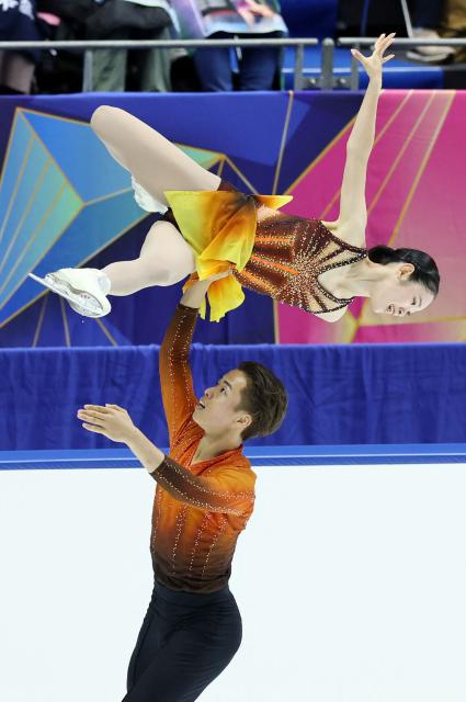 Japan's Yuna Nagaoka (top) and Sumitada Moriguchi perform in the Pairs Short Program at the ISU Grand Prix of Figure Skating 2025/26 NHK Trophy in Kadoma City, Osaka Prefecture on November 7, 2025. (Photo by JIJI Press / AFP) / Japan OUT