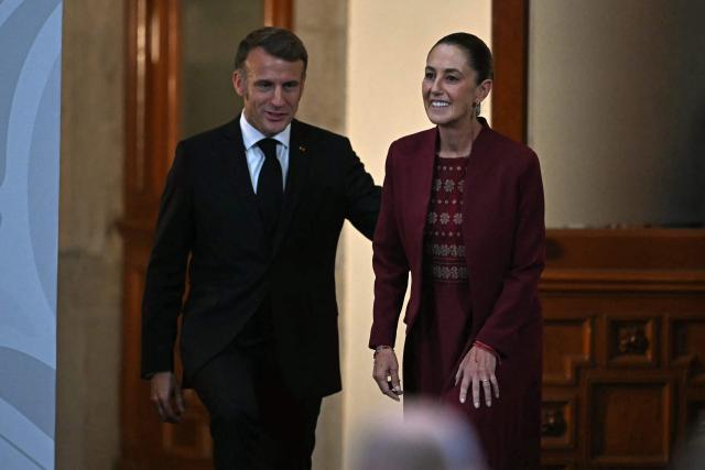 France's President Emmanuel Macron and Mexico's President Claudia Sheinbaum arrive for a joint press conference at the National Palace in Mexico City on November 7, 2025. (Photo by CARL DE SOUZA / AFP)