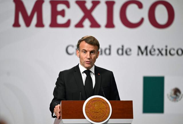France's President Emmanuel Macron speaks next to Mexico's President Claudia Sheinbaum (out of frame) during a joint press conference at the National Palace in Mexico City on November 7, 2025. (Photo by CARL DE SOUZA / AFP)