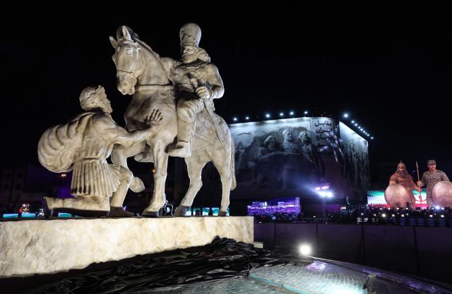 A photograph shows a statue depicting Sasanian king Shapur I capturing Roman emperor Valerian during its unveiling at Enghelab (Revolution) Square in the capital Tehran on November 7, 2025. The event was the latest in a series of unveiling national symbols following Iran's recent 12-day war with Israel in June. The statue was modelled on an original stone engraving in southern Iran, symbolising Iranian triumph over foreign foes. (Photo by AFP)