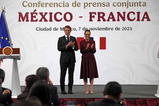 France's President Emmanuel Macron (L) and Mexico's President Claudia Sheinbaum applaud after a joint press conference at the National Palace in Mexico City on November 7, 2025. (Photo by Ludovic MARIN / AFP)