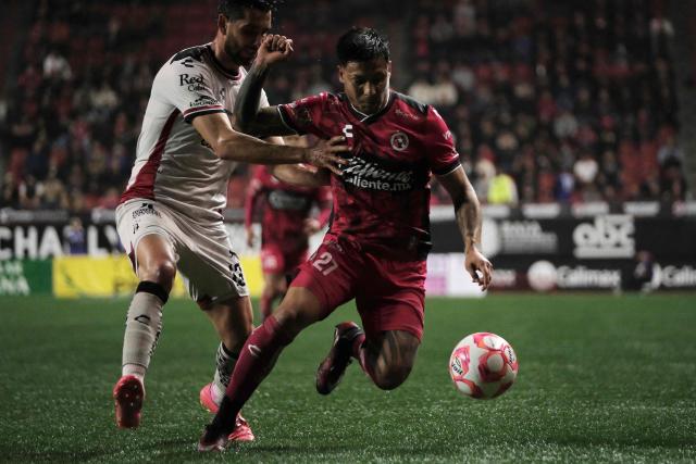 Atlas' defender #13 Gaddi Aguirre and Tijuana's Argentine midfielder #27 Domingo Blanco fight for the ball during the Liga MX Apertura football match between Tijuana and Atlas at Caliente Stadium in Tijuana, Mexico on November 7, 2025. (Photo by Guillermo Arias / AFP)