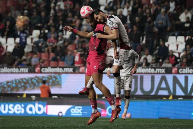 Tijuana's Spanish forward #21 Mourad El Ghezouani and Atlas' defender #13 Gaddi Aguirre fight for the ball during the Liga MX Apertura football match between Tijuana and Atlas at Caliente Stadium in Tijuana, Mexico on November 7, 2025. (Photo by Guillermo Arias / AFP)