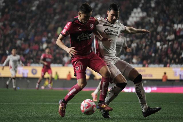 Tijuana's forward #17 Ramiro Arciga and Atlas' defender #04 Adrian Mora fight for the ball during the Liga MX Apertura football match between Tijuana and Atlas at Caliente Stadium in Tijuana, Mexico on November 7, 2025. (Photo by Guillermo Arias / AFP)