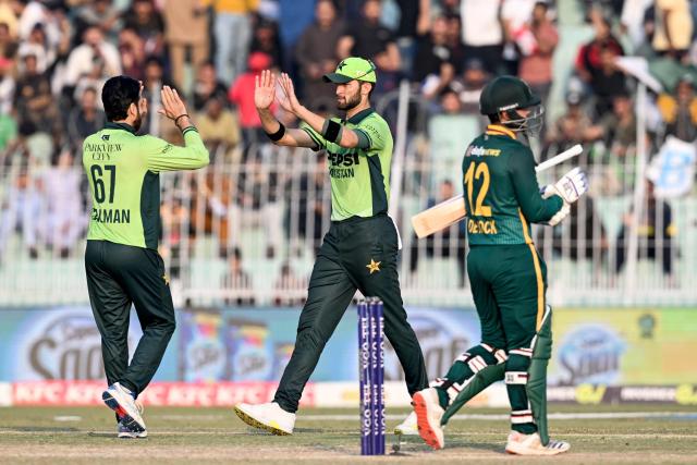 Pakistan's Salman Agha (L) celebrates with captain Shaheen Shah Afridi (C) after taking the wicket of South Africa's Tony de Zorzi during the third and final one-day international (ODI) cricket match between Pakistan and South Africa at the Iqbal Stadium in Faisalabad on November 8, 2025. (Photo by Aamir QURESHI / AFP)