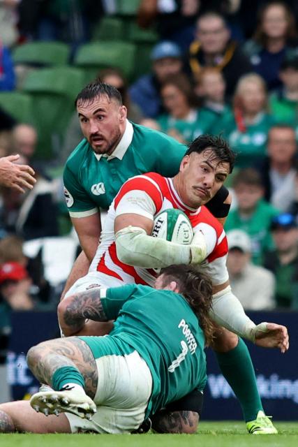 Japan's flanker Ben Gunter is tackled by Ireland's prop Andrew Porter during the Autumn Nations Series international rugby union match between Ireland and Japan at the Aviva Stadium in Dublin, on November 8, 2025. (Photo by Paul Faith / AFP)