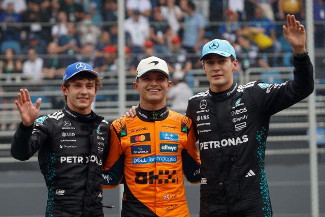 TOPSHOT - Winner McLaren's British driver Lando Norris (C), second-placed Mercedes' Italian driver Kimi Antonelli (L) and third-placed Mercedes' British driver George Russell (R) celebrate after the sprint of the Sao Paulo Formula One Grand Prix at the Jose Carlos Pace racetrack, aka Interlagos, in Sao Paulo, Brazil on November 8, 2025. (Photo by Miguel SCHINCARIOL / AFP)