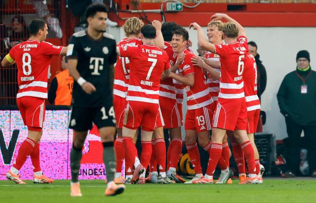 Union Berlin's players celebrate the opening goal by Dutch defender #05 Danilho Doekhi during the German first division Bundesliga football match between 1 FC Union Berlin and FC Bayern Munich in Berlin on November 8, 2025. (Photo by Odd ANDERSEN / AFP) / DFL REGULATIONS PROHIBIT ANY USE OF PHOTOGRAPHS AS IMAGE SEQUENCES AND/OR QUASI-VIDEO