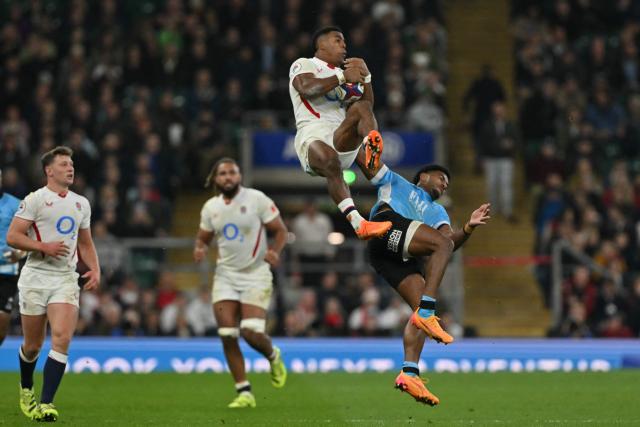 Fiji's wing Selestino Ravutaumada (R) receives a yellow card for this challenge on England's wing Immanuel Feyi-Waboso (3L) during the Autumn Nations Series international rugby union match between England and Fiji at Allianz Stadium, Twickenham, in south-west London, on November 8, 2025. (Photo by Glyn KIRK / AFP)