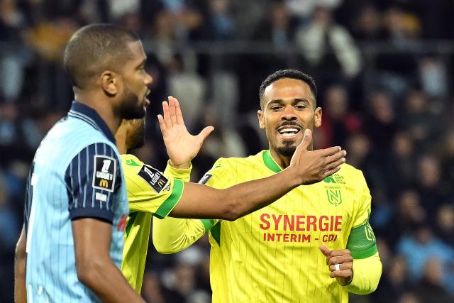 Nantes' French defender #98 Kelvin Amian (R) celebrates with a teammate the goal of Nantes' French forward #10 Matthis Abline during the French L1 football match between Le Havre AC and FC Nantes at the Stade Oceane in Le Havre, north-western France, on November 8, 2025. (Photo by Lou BENOIST / AFP)