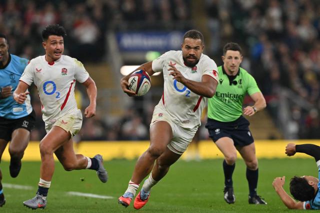 England's centre Ollie Lawrence makes a break during the Autumn Nations Series international rugby union match between England and Fiji at Allianz Stadium, Twickenham, in south-west London, on November 8, 2025. (Photo by Glyn KIRK / AFP)