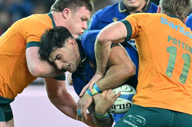Italy's center #12 Tommaso Menoncello is tackled by Australia's wing #11 Harry Potter during the Autumn Nations Series international rugby union match between Italy and Australia (wallabies) at the Friuli stadium in Udine on November 8, 2025. (Photo by Stefano RELLANDINI / AFP)