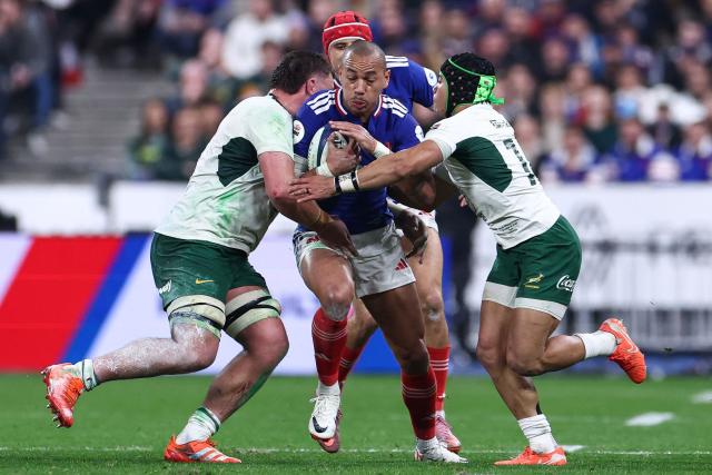 France's centre #12 Gael Fickou (C) is tackled by South Africa's wing #14 Cheslin Kolbe (R) during the Autumn Nations Series international rugby union test match between France and South Africa at the Stade de France in Saint-Denis, Paris' suburb, on November 8, 2025. (Photo by FRANCK FIFE / AFP)