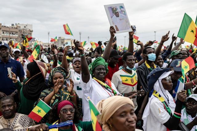 Supporters of Senegal’s Prime Minister Ousmane Sonko wave Senegal flags during a rally in Dakar, on November 8, 2025. (Photo by PATRICK MEINHARDT / AFP)