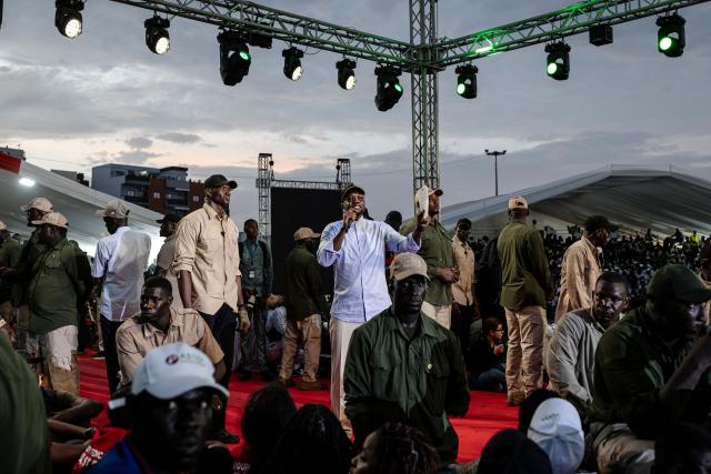 Senegal's Prime Minister Ousmane Sonko gestures on stage as he addresses supporters at a rally in Dakar on November 8, 2025. (Photo by PATRICK MEINHARDT / AFP)