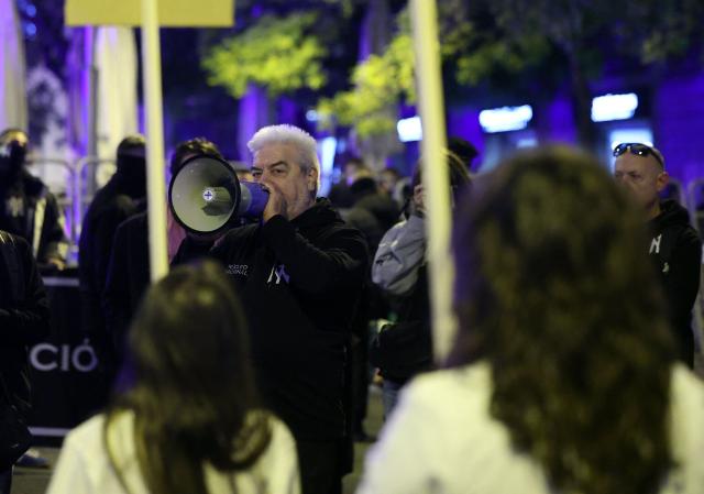 Enrique Lemus, one of the Spanish neonazi group Nucleo Nacional's leader, speaks in a megaphone during a demonstration called to protest 'against the corrupt politicians' in front of the Spanish Congress in Madrid, on November 11, 2025. The police charged and fired tear gas to disperse the demonstration and detained at least three protestors of the group. The Nucleo Nacional (National Core) movement, investigated for hate incitement, was born in the aftermath of the protests in front of the Spanish Socialist Party (PSOE) headquarters in Madrid against the amnesty granted to Catalan independence leaders in 2023. (Photo by Thomas COEX / AFP)