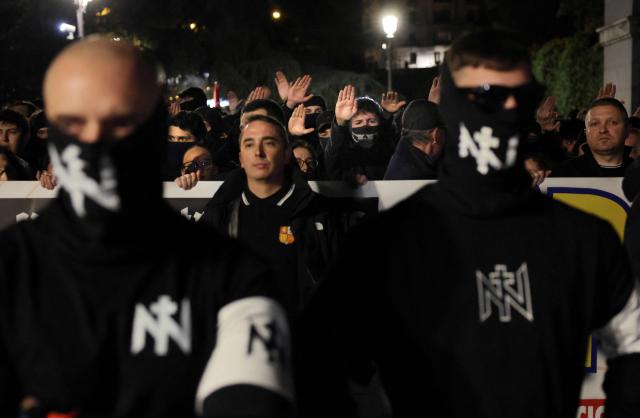 CORRECTION / Members of Spanish neonazi group Nucleo Nacional give a Nazi salute during a demonstration called to protest 'against the corrupt politicians' in front of the Spanish Congress in Madrid, on November 11, 2025. The police charged and fired tear gas to disperse the demonstration and detained at least three protestors of the group. The Nucleo Nacional (National Core) movement, investigated for hate incitement, was born in the aftermath of the protests in front of the Spanish Socialist Party (PSOE) headquarters in Madrid against the amnesty granted to Catalan independence leaders in 2023. (Photo by Thomas COEX / AFP) / The erroneous mention[s] appearing in the metadata of this photo by Thomas COEX has been modified in AFP systems in the following manner: [on November 8, 2025] instead of [on November 11, 2025]. Please immediately remove the erroneous mention[s] from all your online services and delete it (them) from your servers. If you have been authorized by AFP to distribute it (them) to third parties, please ensure that the same actions are carried out by them. Failure to promptly comply with these instructions will entail liability on your part for any continued or post notification usage. Therefore we thank you very much for all your attention and prompt action. We are sorry for the inconvenience this notification may cause and remain at your disposal for any further information you may require.