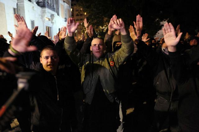 CORRECTION / Members of Spanish neonazi group Nucleo Nacional give a Nazi salute during a demonstration called to protest 'against the corrupt politicians' in front of the Spanish Congress in Madrid, on November 11, 2025. The police charged and fired tear gas to disperse the demonstration and detained at least three protestors of the group. The Nucleo Nacional (National Core) movement, investigated for hate incitement, was born in the aftermath of the protests in front of the Spanish Socialist Party (PSOE) headquarters in Madrid against the amnesty granted to Catalan independence leaders in 2023. (Photo by Thomas COEX / AFP) / The erroneous mention[s] appearing in the metadata of this photo by Thomas COEX has been modified in AFP systems in the following manner: [on November 8, 2025] instead of [on November 11, 2025]. Please immediately remove the erroneous mention[s] from all your online services and delete it (them) from your servers. If you have been authorized by AFP to distribute it (them) to third parties, please ensure that the same actions are carried out by them. Failure to promptly comply with these instructions will entail liability on your part for any continued or post notification usage. Therefore we thank you very much for all your attention and prompt action. We are sorry for the inconvenience this notification may cause and remain at your disposal for any further information you may require.