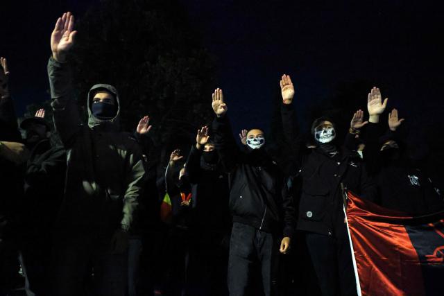 CORRECTION / Members of Spanish neonazi group Nucleo Nacional give a Nazi salute during a demonstration called to protest 'against the corrupt politicians' in front of the Spanish Congress in Madrid, on November 11, 2025. The police charged and fired tear gas to disperse the demonstration and detained at least three protestors of the group. The Nucleo Nacional (National Core) movement, investigated for hate incitement, was born in the aftermath of the protests in front of the Spanish Socialist Party (PSOE) headquarters in Madrid against the amnesty granted to Catalan independence leaders in 2023. (Photo by Thomas COEX / AFP) / The erroneous mention[s] appearing in the metadata of this photo by Thomas COEX has been modified in AFP systems in the following manner: [on November 8, 2025] instead of [on November 11, 2025]. Please immediately remove the erroneous mention[s] from all your online services and delete it (them) from your servers. If you have been authorized by AFP to distribute it (them) to third parties, please ensure that the same actions are carried out by them. Failure to promptly comply with these instructions will entail liability on your part for any continued or post notification usage. Therefore we thank you very much for all your attention and prompt action. We are sorry for the inconvenience this notification may cause and remain at your disposal for any further information you may require.