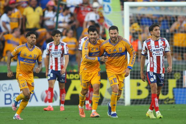 Tigres' Argentine forward #07 Angel Correa (C) celebrates with teammate French forward #10 Andre-Pierre Gignac scoring his team's first goal during the Liga MX Apertura tournament football match between Tigres and San Luis at the UANL University Stadium in San Nicolas de los Garza, Nuevo Leon State, Mexico on November 8, 2025. (Photo by Julio Cesar AGUILAR / AFP)