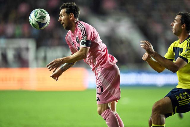 Inter Miami's Argentine forward #10 Lionel Messi (L) is pushed from behind by Nashville's US defender #05 Jack Maher during the Major League Soccer (MLS) playoff football match between Inter Miami and Nashville SC at Chase Stadium in Fort Lauderdale, Florida on November 8, 2025. (Photo by Chandan Khanna / AFP)