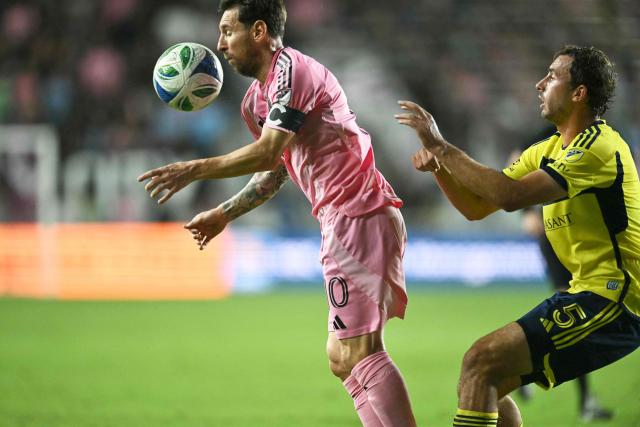 Inter Miami's Argentine forward #10 Lionel Messi (L) is pushed from behind by Nashville's US defender #05 Jack Maher during the Major League Soccer (MLS) playoff football match between Inter Miami and Nashville SC at Chase Stadium in Fort Lauderdale, Florida on November 8, 2025. (Photo by Chandan Khanna / AFP)
