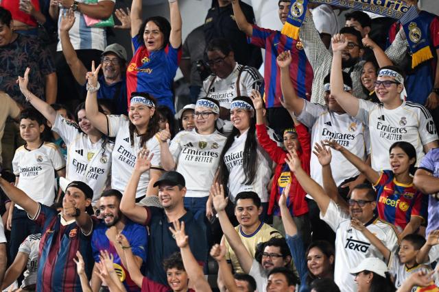 Fans of Real Madrid cheer for their team during the exhibition friendly football match between Spain's Barcelona Legends and Real Madrid Legends at the Jorge "El Magico" Gonzalez Stadium in San Salvador on November 8, 2025. (Photo by Marvin RECINOS / AFP)