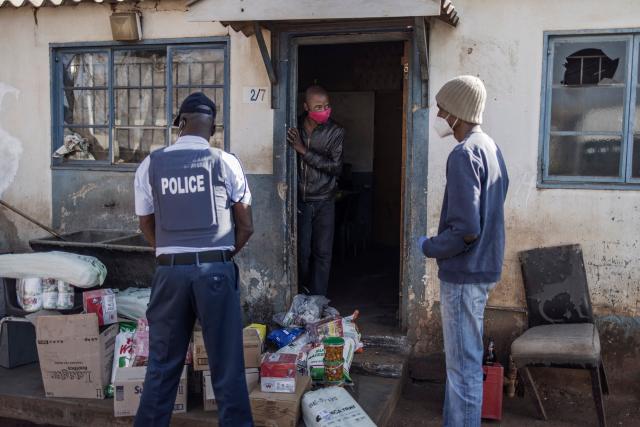 (FILES) Residents of the Nguni Hostels in Vosloorus are questioned by a South African policeman about good found in their dwelling, on July 27, 2021 during a joint operation between the South Africa Police Service (SAPS) and the South Africa National Defence Forces (SANDF). The trial of Duduzile Zuma-Sambudla, daughter of South Africa's former president Jacob Zuma, accused of inciting 2021 riots that left more than 350 people dead, was set by the Durban High Court to start November 10, 2025.
Duduzile Zuma-Sambudla, 42, is among several people charged with inciting terrorism and public violence via posts on social media after Zuma was sent to prison in July 2021 for refusing to testify in corruption proceedings against him.
The explosion of rioting and looting that followed was the deadliest unrest in South Africa since the fall of the white-minority government in 1994. 
Zuma-Sambudla denies the charges and claims the case is politically motivated. (Photo by MARCO LONGARI / AFP)