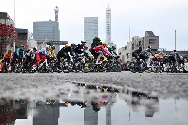 Riders take a corner during the Tour de France Saitama Criterium cycling race in Saitama on November 9, 2025. (Photo by GREG BAKER / AFP)