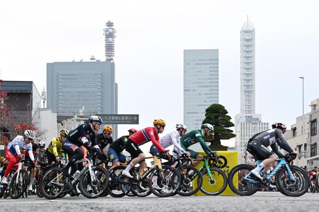 Riders take a corner during the Tour de France Saitama Criterium cycling race in Saitama on November 9, 2025. (Photo by GREG BAKER / AFP)