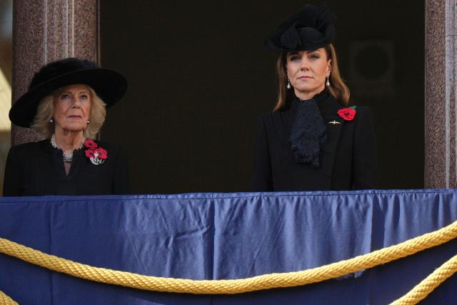 Britain's Catherine, Princess of Wales (R) and Britain's Queen Camilla (L) look on from a balcony during the Remembrance Sunday ceremony at the Cenotaph on Whitehall in central London on November 9, 2025. Remembrance Sunday is an annual commemoration held on the closest Sunday to Armistice Day, November 11, the anniversary of the end of the First World War and services across Commonwealth countries remember servicemen and women who have fallen in the line of duty since WWI. (Photo by Alastair Grant / POOL / AFP)