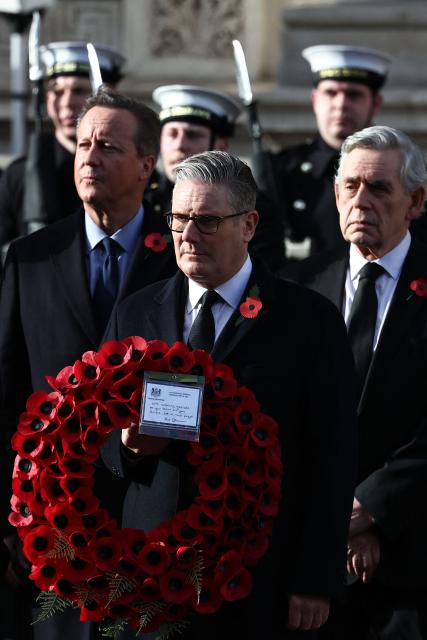 Britain's Prime Minister Keir Starmer (C), and former prime ministers David Cameron (L) and Gordon Brown (R) attend the Remembrance Sunday ceremony at the Cenotaph on Whitehall in central London on November 9, 2025. Remembrance Sunday is an annual commemoration held on the closest Sunday to Armistice Day, November 11, the anniversary of the end of the First World War and services across Commonwealth countries remember servicemen and women who have fallen in the line of duty since WWI. (Photo by HENRY NICHOLLS / POOL / AFP)