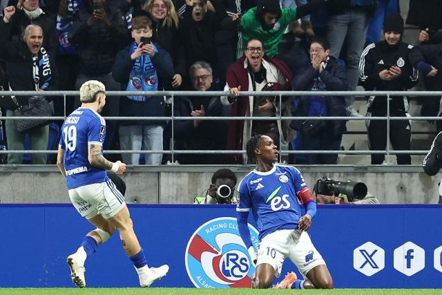 Strasbourg’s Dutch forward #10 Emanuel Emegha (R) celebrates scoring his team's first goal during the French L1 football match between RC Strasbourg Alsace and Lille LOSC at the Stade de la Meinau in Strasbourg, eastern France, on November 9, 2025. (Photo by Frederick FLORIN / AFP)