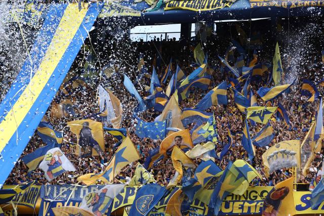 Fans of Boca Juniors cheer for their team ahead of the Argentine Professional Football League 2025 Clausura Tournament match between Boca Juniors and River Plate at the La Bombonera Stadium in Buenos Aires on November 9, 2025. (Photo by Alejandro PAGNI / AFP)