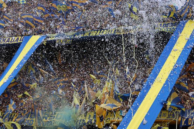 Fans of Boca Juniors cheer for their team ahead of the Argentine Professional Football League 2025 Clausura Tournament match between Boca Juniors and River Plate at the La Bombonera Stadium in Buenos Aires on November 9, 2025. (Photo by Alejandro PAGNI / AFP)