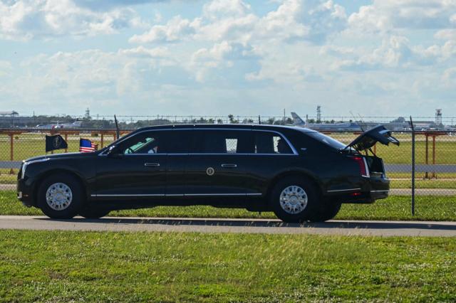 The US President's official vehicle known as "The Beast", drives with its trunk open, as US President Donald Trump's motorcade travels to Palm Beach International Airport in West Palm Beach, Florida, on November 9, 2025. Trump is returning to Washington DC after spending part of the weekend at his Florida residence of Mar-a-Lago. (Photo by Jim WATSON / AFP)